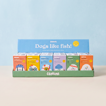 Canumi six-flavour discovery bundle for dogs, with all six seafood toppers in the branded display box