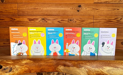 All six Canumi cat seafood topper flavours lined up in their colourful boxes